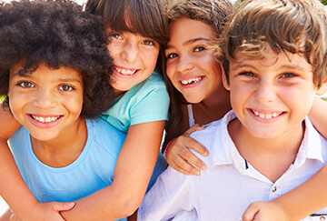 Group of happy kids about to play basketball