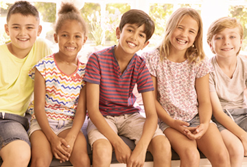 Group of kids sitting and smiling